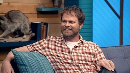 Rainn Wilson Wears a Short Sleeved Plaid Shirt & Colorful Sneakers